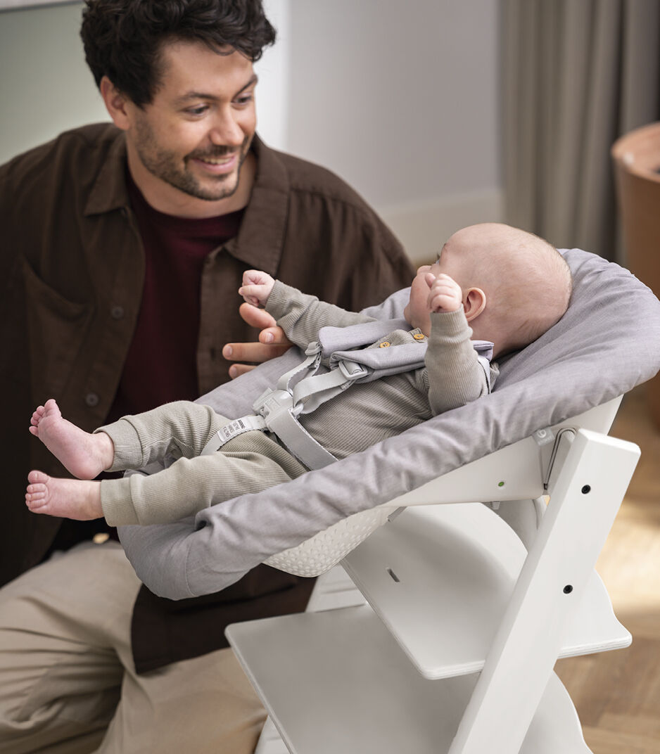 Tripp Trapp® Chair White with Newborn Set, Grey. Close-up.